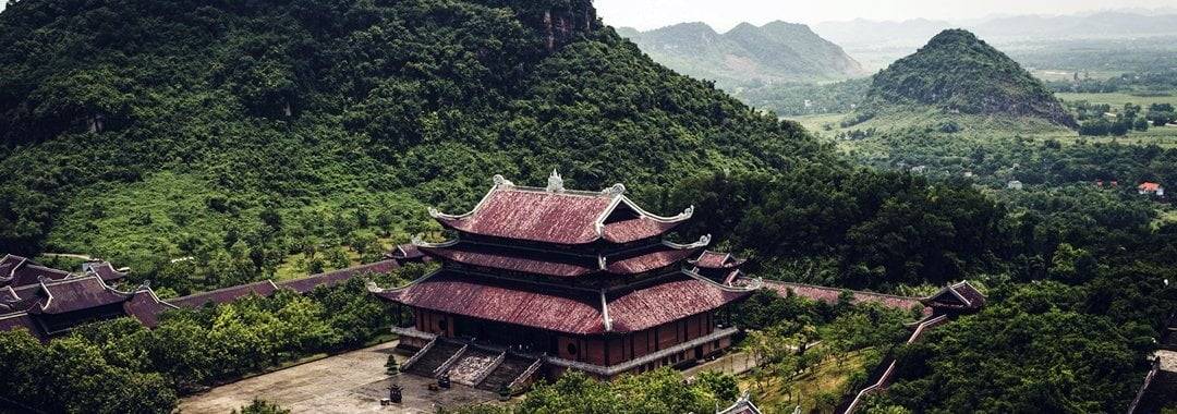 Temple surrounded by mountains inTam Coc, Vietnam